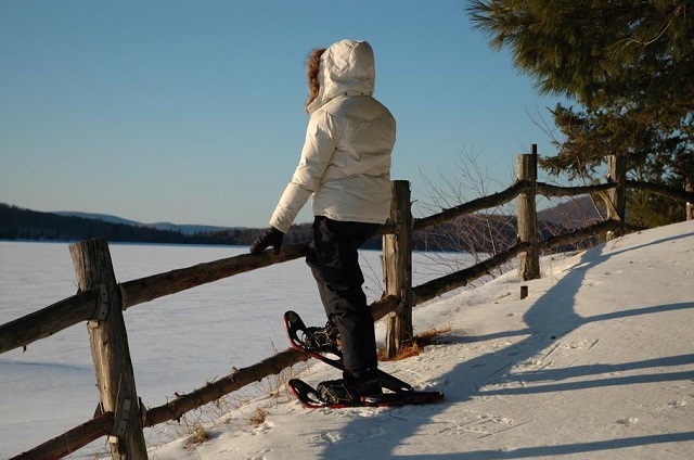 A woman is snowshoeing